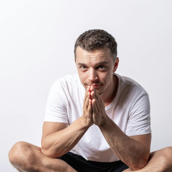 Person meditating peacefully after a workout, with a serene expression.